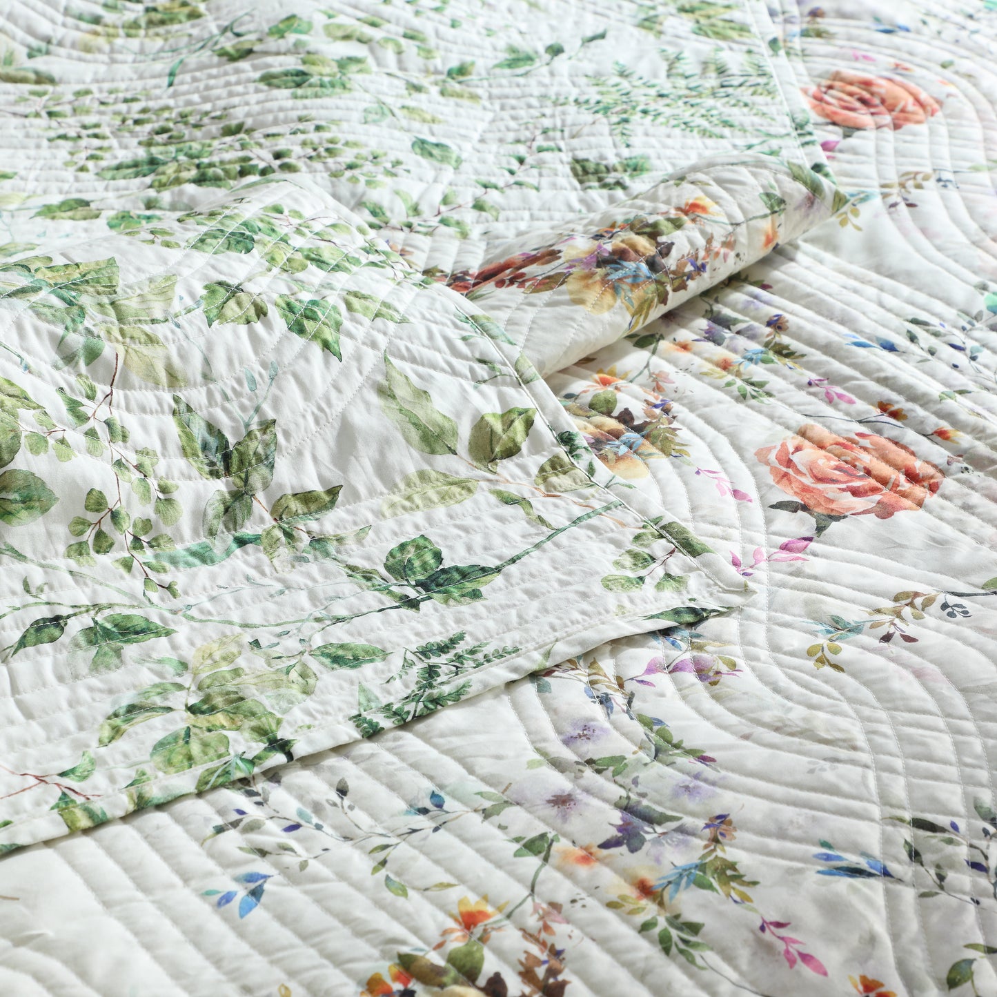 organic floral quilted dohar with green leaves and colourful flowers.