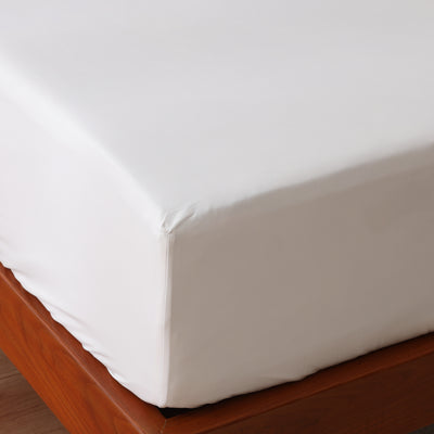 Corner detail of white 1000 TC organic cotton fitted sheet – 35cm elasticated drop all around, soft and silky high thread count weave, Whites of London India