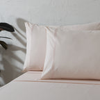 Peach Mist 200TC organic cotton dyed embroidered sheet set – pastel peach flat sheet and housewife pillowcases, subtle embroidery detail, single and king sizes
