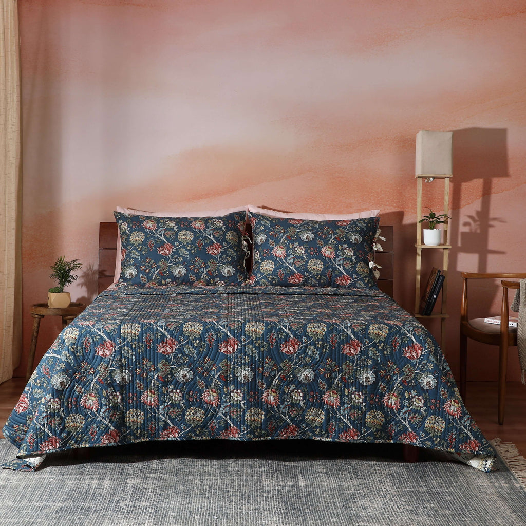 Chintz reversible dohar set on a styled bed – deep blue ground with intricate botanical blooms and flowing vines, organic cotton percale, Whites of London