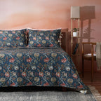Flat lay of Chintz cotton percale reversible dohar – deep blue botanical front alongside ivory and coral floral reverse, 100% organic cotton