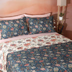 Chintz dohar set showing the ivory reverse side – warm coral and blue florals with ornate botanical motifs, lightly quilted organic cotton percale