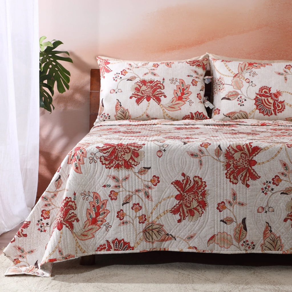 Jacobean Summer dohar showing the coral and terracotta reverse – warm, dense floral botanical print, wave-stitched quilting, cotton percale, Whites of London India