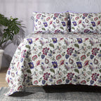 Lavender Fields percale dohar set on a made bed – painterly floral design in lilac, sage and blush tones, lightly quilted organic cotton