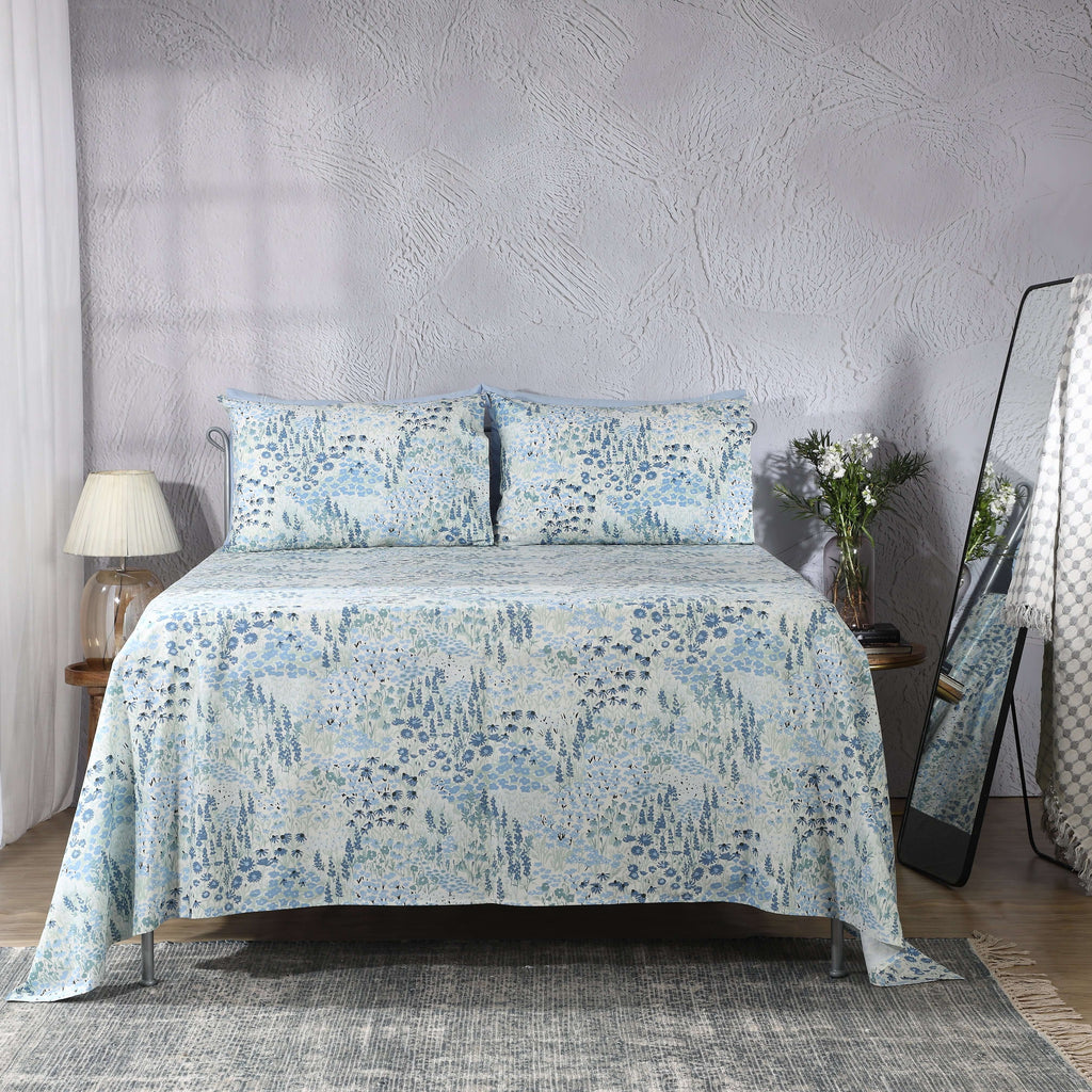 Windflower sheet set on a styled bed – meadow-inspired wildflower print in soft blue, sage and ivory on 200 TC organic cotton percale, Whites of London