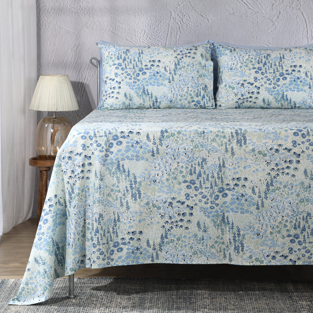 Windflower 200 TC organic percale flat sheet and pillowcase set – airy wildflower and leafy detail print in soft blue and sage on an ivory ground