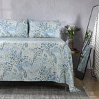 Windflower organic cotton percale sheet set on a made bed – delicate scattered wildflowers in blue and sage, calm and refreshing bedroom styling, Whites of London India