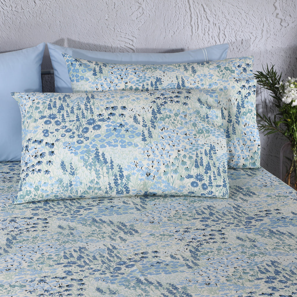 Close-up of Windflower percale pillowcases – fine leafy sprays and delicate wildflower print in soft blue, sage and ivory on 200 TC organic cotton