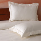 Close-up of cord embroidery detail on an ivory 600TC organic cotton Oxford pillowcase flange – tailored, hotel-quality finish, Whites of London