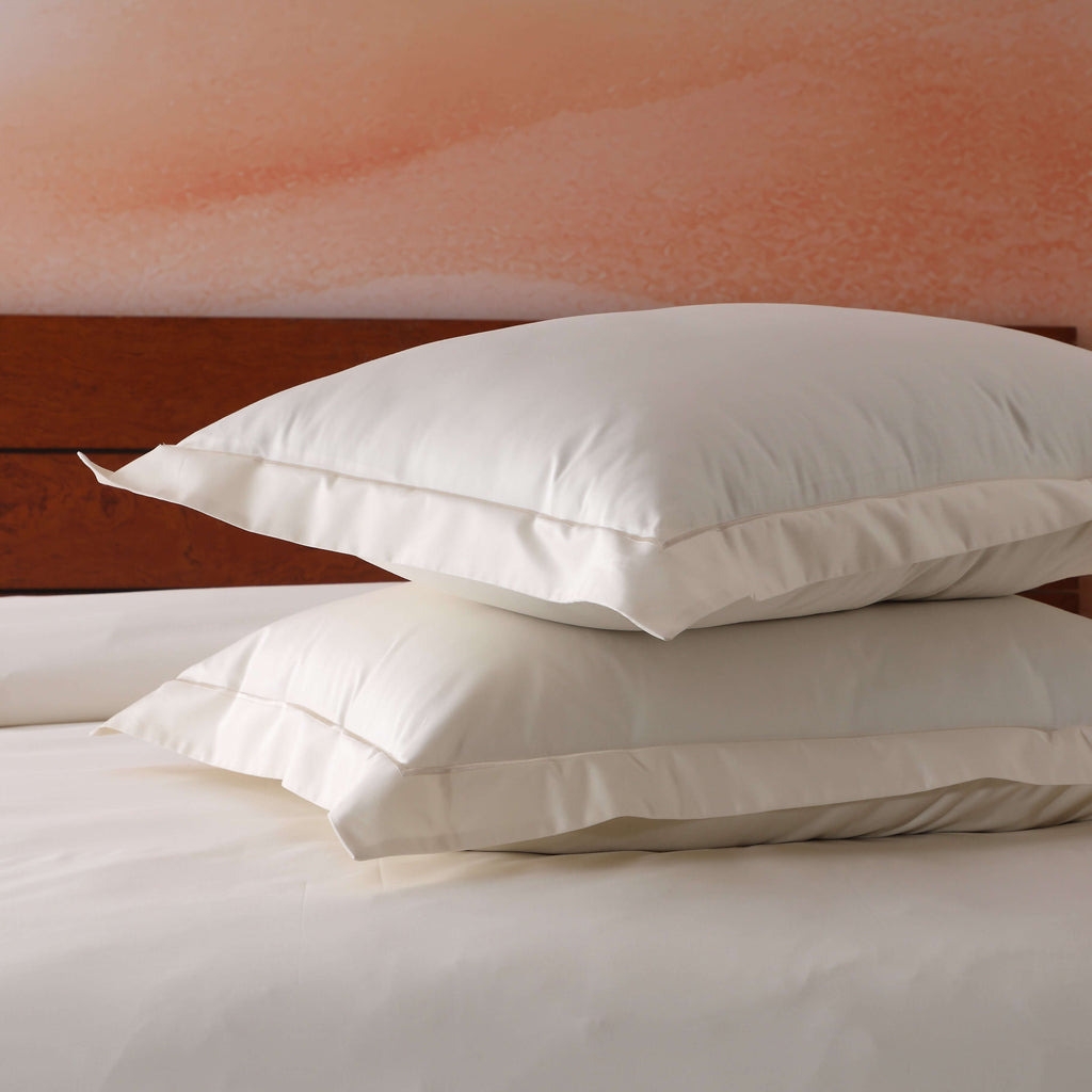 Pair of ivory oxford pillowcases flat lay – 600 thread count organic cotton with embroidered border, 50x75cm