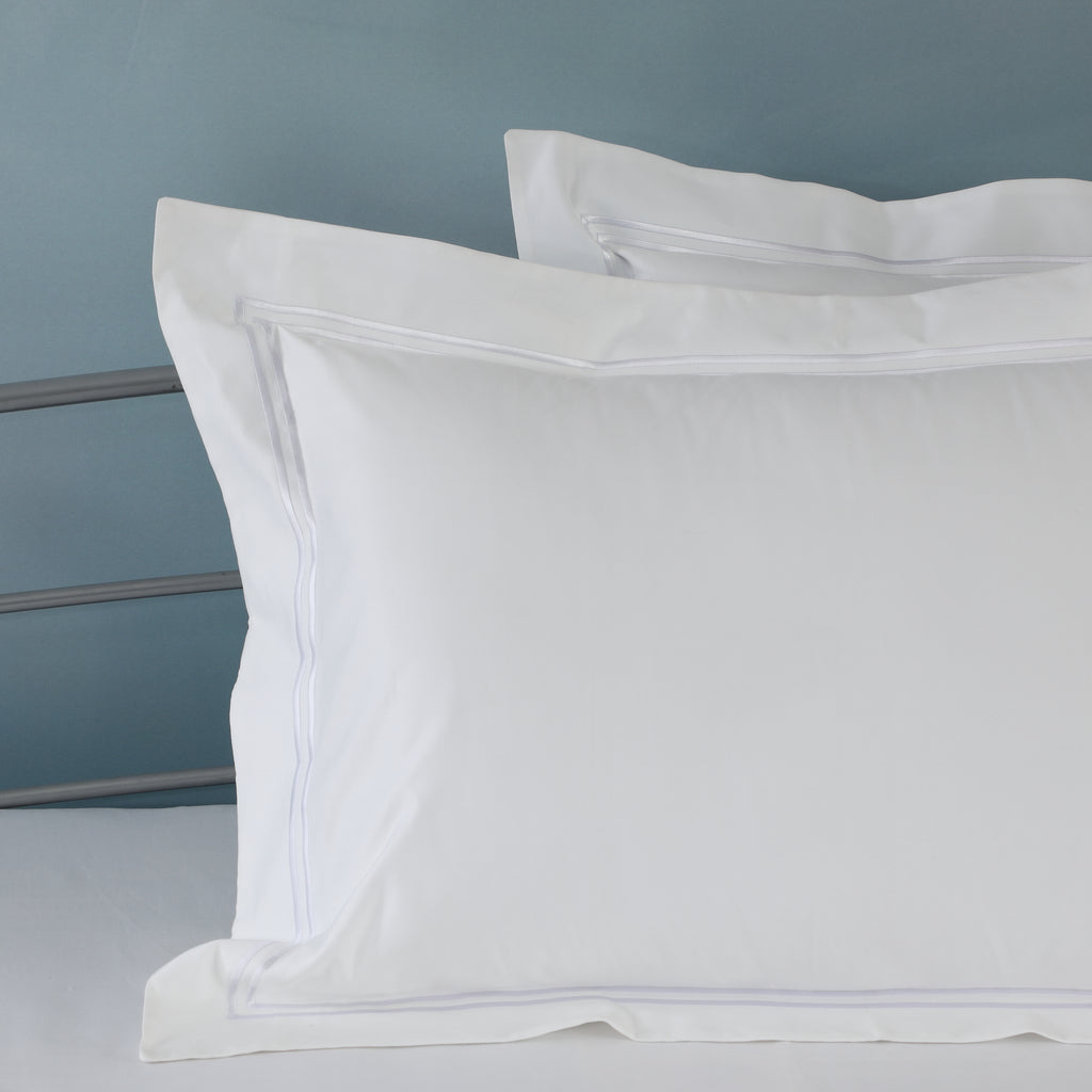 Close-up of two-line marrow embroidery on three sides of a white 1000 TC organic cotton duvet cover – subtle, sophisticated detailing