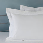 Close-up of two-line marrow embroidery on three sides of a white 1000 TC organic cotton duvet cover – subtle, sophisticated detailing