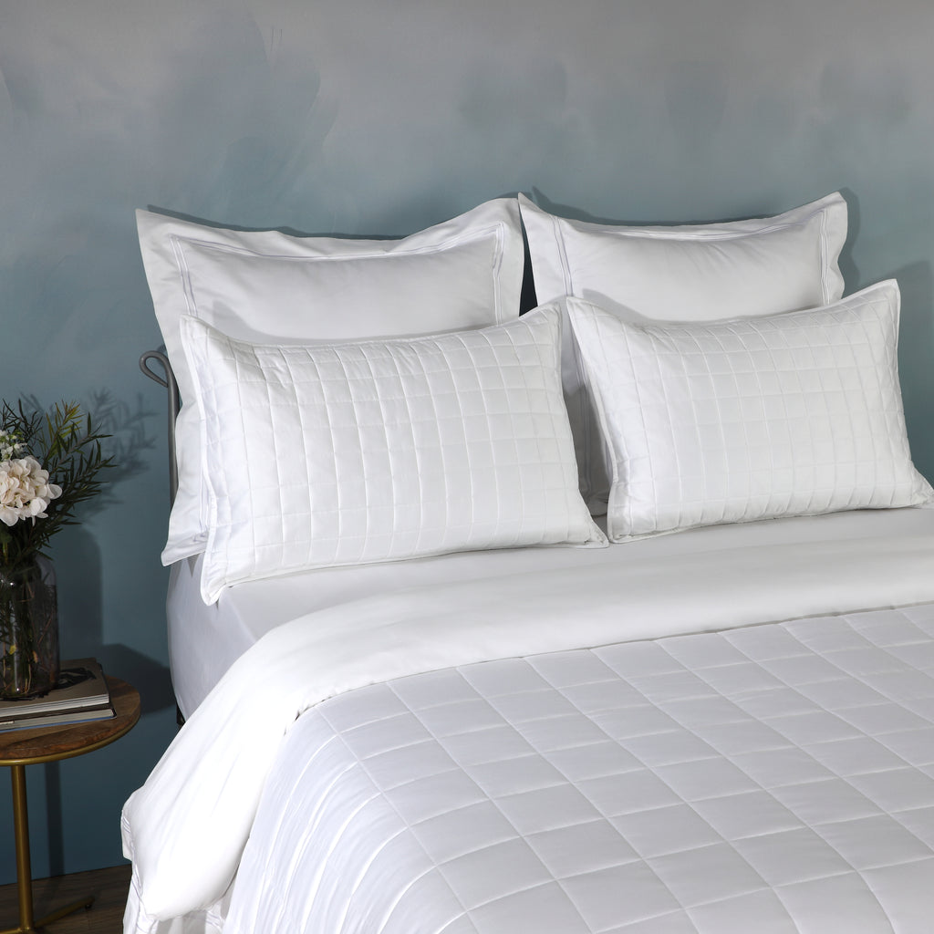 White bamboo cotton coverlet and sham set on a made bed – naturally hypoallergenic and moisture-wicking 60/40 bamboo cotton blend, soft quilted texture, Whites of London