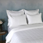 White bamboo cotton coverlet and sham set on a made bed – naturally hypoallergenic and moisture-wicking 60/40 bamboo cotton blend, soft quilted texture, Whites of London