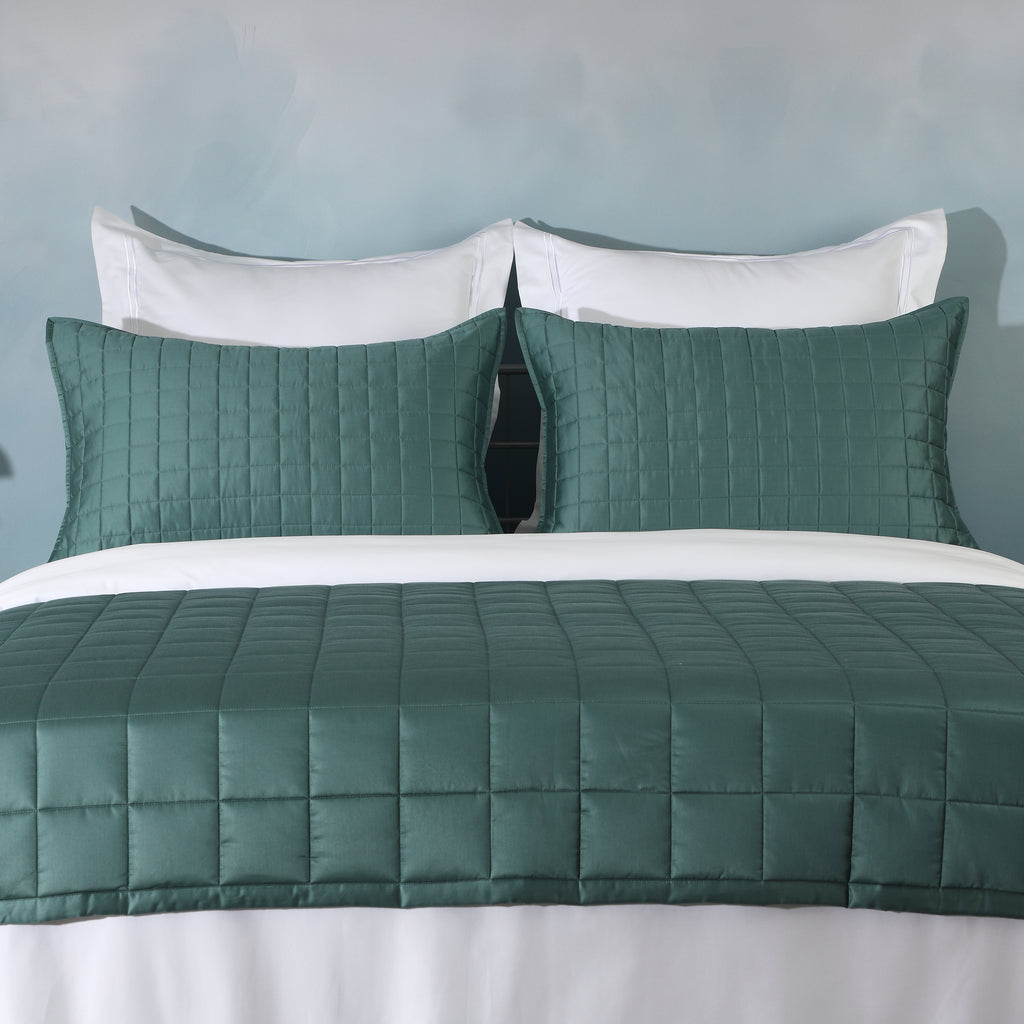Teal bamboo cotton coverlet and sham set on a made bed – naturally hypoallergenic and moisture-wicking bamboo cotton blend, soft quilted texture, Whites of London