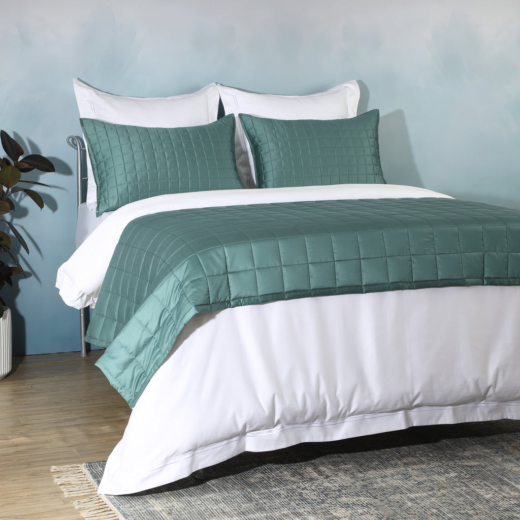 Close-up of teal bamboo cotton bedspread quilting – timeless stitch pattern on a soft 60% bamboo 40% cotton blend, hypoallergenic and moisture-wicking, Whites of London