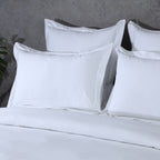 Luxury white oxford pillowcases on a neatly made bed – 600 thread count organic cotton, breathable and durable, Whites of London India