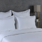 Detail shot of white 600 TC organic cotton euro pillowcase – single embroidered line, silky dense weave, 65x65cm