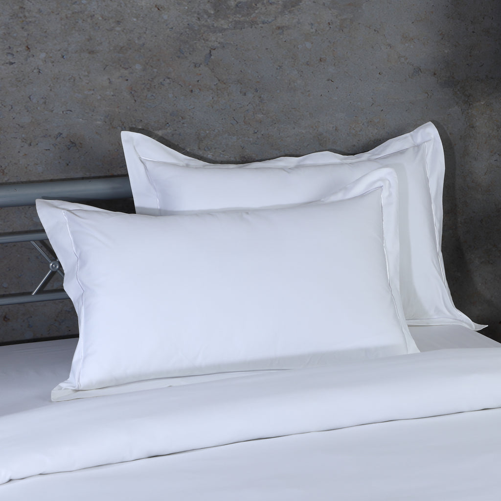Fabric texture detail of white 600 TC oxford pillowcase – smooth, tightly woven organic cotton with embroidered edge, Whites of London