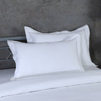 Fabric texture detail of white 600 TC oxford pillowcase – smooth, tightly woven organic cotton with embroidered edge, Whites of London