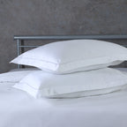 White oxford pillowcase set on a styled bed – 600 TC organic cotton with single embroidered border on face and flange, Whites of London