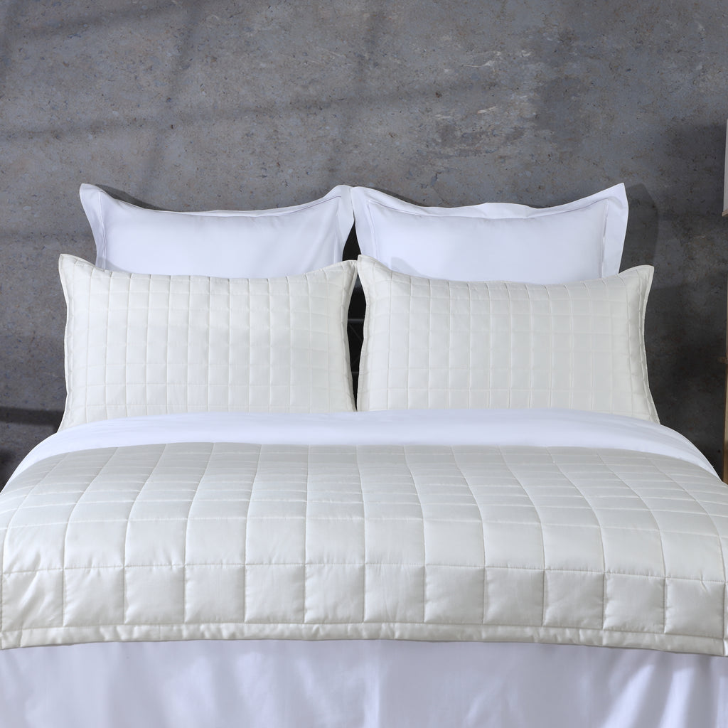 Ivory bamboo cotton coverlet and sham set on a made bed – soft quilted texture in a warm ivory tone, naturally hypoallergenic and moisture-wicking bamboo cotton blend