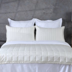 Ivory bamboo cotton coverlet and sham set on a made bed – soft quilted texture in a warm ivory tone, naturally hypoallergenic and moisture-wicking bamboo cotton blend