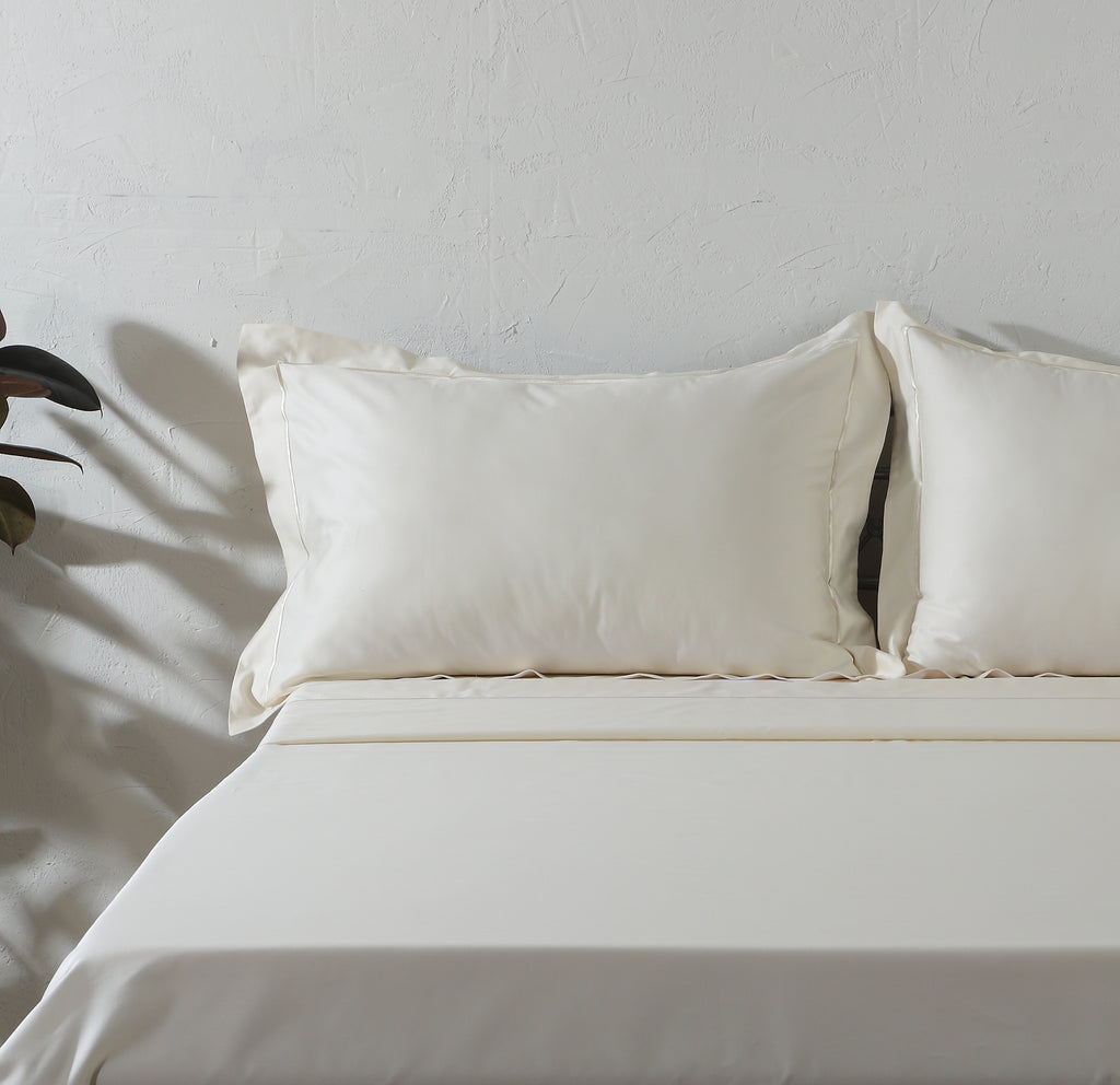Ivory 600TC organic cotton embroidered sheet set on a styled bed – marrow embroidery line on flat sheet, cord embroidery on Oxford pillowcases, silky and smooth, Whites of London India