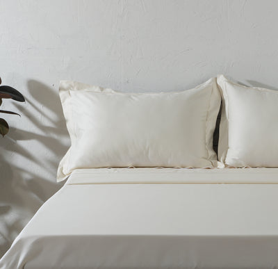 Ivory 600TC organic cotton embroidered sheet set on a styled bed – marrow embroidery line on flat sheet, cord embroidery on Oxford pillowcases, silky and smooth, Whites of London India