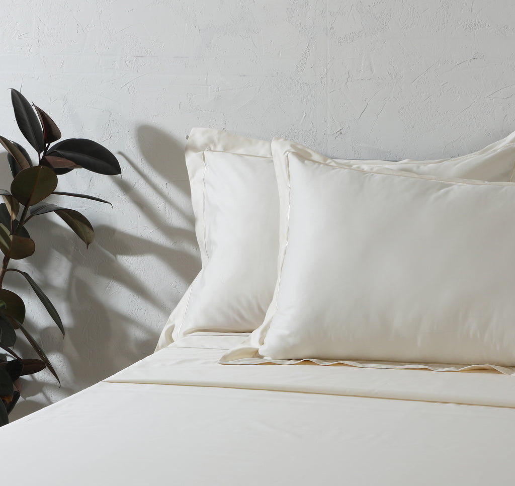 600 thread count organic cotton embroidered ivory sheet set on a made bed – warm ivory tone, soft and breathable, with delicate embroidery detailing, Whites of London