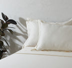 600 thread count organic cotton embroidered ivory sheet set on a made bed – warm ivory tone, soft and breathable, with delicate embroidery detailing, Whites of London