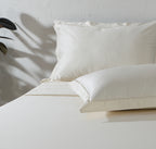 Ivory 600TC organic cotton Oxford pillowcase with cord embroidery detail all around the flange – smooth, dense weave, part of the embroidered sheet set by Whites of London
