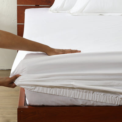 1000 thread count white organic cotton fitted sheet on a made bed – deep 35cm drop, generous elasticated fit, pristine and wrinkle-free
